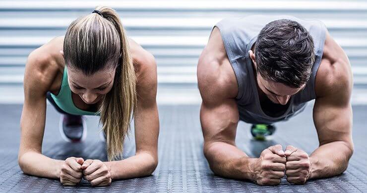 man and woman doing forearm planks